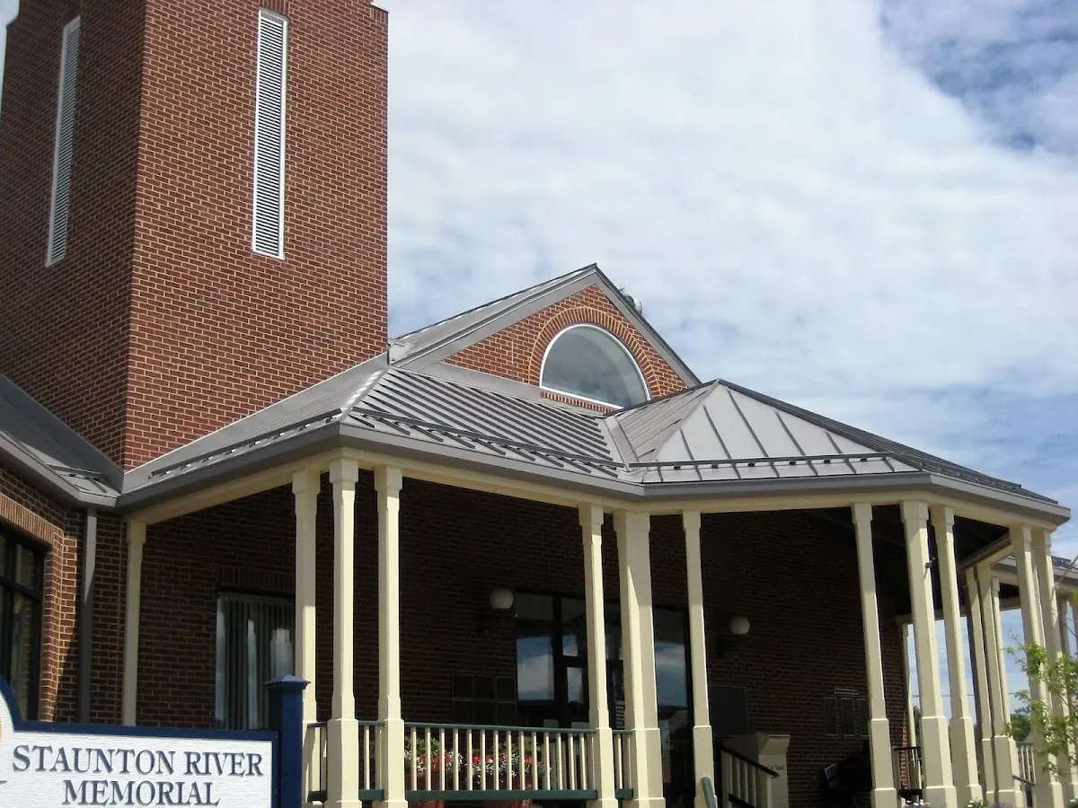 Skilled roofing craftsmen working on a residential roof in New London